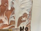 a close up of a piece of art on a easel