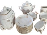 many plates and cups and a teapot on the table