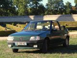 a green car that is parked in the grass
