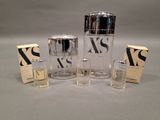 three bottles of perfume are sitting on a table next to a box