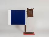 a close up of a blue and white flag on a wooden stand