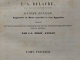 an old book with black writing on it sitting on top of a table