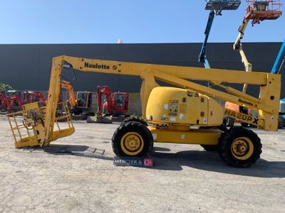 a yellow crane that is parked in a parking lot