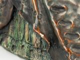 a close up of a statue of a man with a hat on