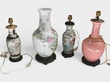 three vases and a lamp on a table with a white background