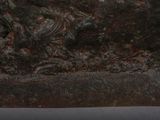a close up of a sculpture of a bird on a rock
