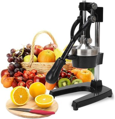 a juicer that is sitting next to a basket of fruit