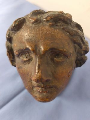 statue of a woman ' s head on a blue cloth