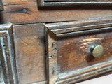 a close up of a wooden chest of drawers