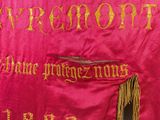 an image of a close up of a red cloth with gold writing
