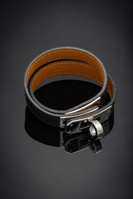 a close up of a black leather bracelet with a silver buckle