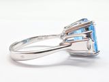 a ring with a blue topaz stone and a silver band
