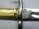 a close up of a knife on a white surface