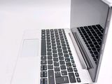 a laptop computer sitting on top of a white table
