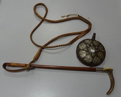 a cane and a hat on a white table