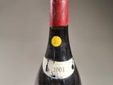 a bottle of red wine sitting on top of a table