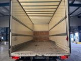 the back of a moving truck with the door open in a warehouse