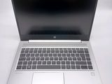 an open laptop computer sitting on top of a white table