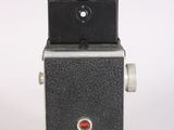 a black camera with a red button on it