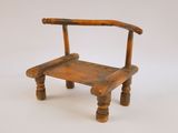 une petite chaise en bois posée sur une surface blanche