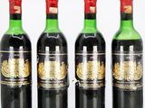 four bottles of wine are lined up in a row