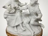 a white figurine of two children playing with a dog