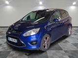 the blue car is parked on a checkered floor in the garage