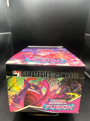 a box of pokemon trading cards on a black background