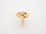 a close up of a gold ring with a diamond on it