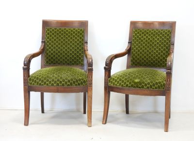 pair of green upholstered chairs with wooden arms and arms