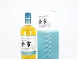 a bottle of single malt whisky next to a blue box