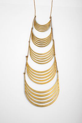 a gold plated necklace with a long chain hanging from it