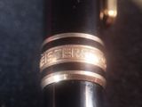 a close up of a fountain pen with a ring on it