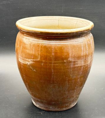 a large brown pot sitting on top of a table