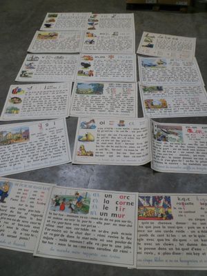 a pile of children ' s books on the floor