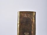 a black and gold lighter sitting on top of a table