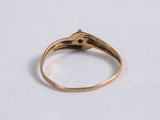 a close up of a gold ring on a white surface
