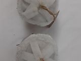 two balls of cotton on a white surface