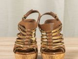 an image of a pair of women ' s sandals on a wooden table