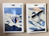 two tags with a picture of a plane on them