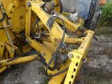 a large yellow machine that is sitting in the dirt