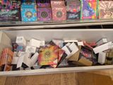 a white box filled with assorted items on a wooden floor