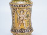 a small vase with a picture of a man on it