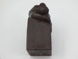 sculpture of a bear on a block of chocolate on a white surface