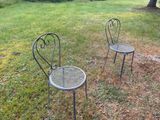 two chairs that are sitting in the grass