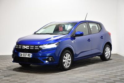 une voiture bleue est garée dans une pièce au sol à carreaux