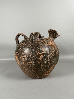 an image of a black and brown vase on a white background