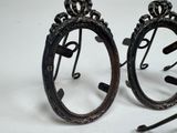two pairs of earrings that are sitting on a table