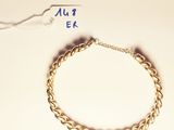 a gold bracelet with a chain attached to it