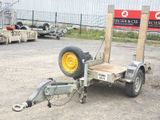 a trailer with a tire attached to it in a parking lot